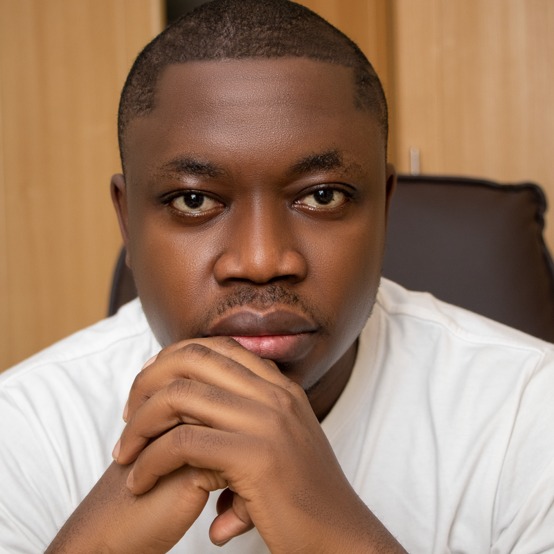 Close up portrait of an adult man in a thoughtful pose indoors.